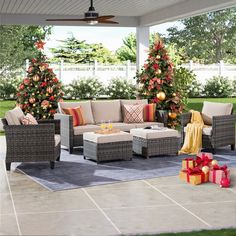 an outdoor living room with christmas trees and presents