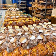 breads and pastries on display in a bakery