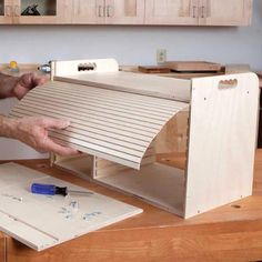 a man is working on a project in his kitchen with woodworking tools and plywood