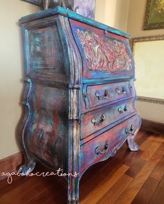 an old dresser is painted blue and pink