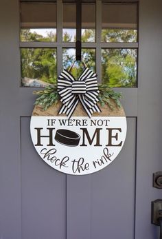 a door with a sign that says if we're not home back the rink