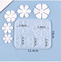 four flower shaped ice trays are shown with measurements for each individual size and shape