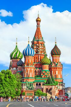 people are standing in front of an ornate building with domes on the top and sides