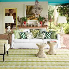 a living room filled with lots of furniture next to a fire place and a chandelier