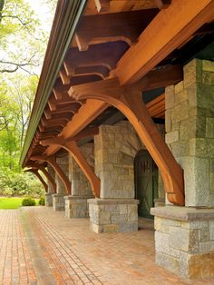 an outdoor covered walkway with stone pillars and columns