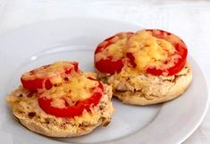 two mini sandwiches with tomatoes and cheese on them