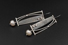 Long Silver Geometric Earrings with cultured Fresh Water Pearls. These Drop earrings measure 6.5 cm in length including the hook, and 1.6cm in width. The Pearls are 9mm approximately in diameter. Get a 10% discount off your next order by subscribing at Diapiro's newsletter. Link for coupon code https://mailchi.mp/56f529763263/diapiro All of my products are carefully handmade with authentic techniques of Goldsmithing such as Sawing - Forming - Rasping - Sanding - Soldering - Engraving- Hammering Modern Long Drop Pearl Earrings, Modern Linear Drop Earrings For Jewelry Making, Modern Silver Long Drop Pearl Earrings, Contemporary Linear Earrings For Gifts, Modern Metal Pearl Earrings For Pierced Ears, Modern Metal Pearl Earrings, Bauhaus Jewelry, January Jewelry, Modern Pearl Earrings