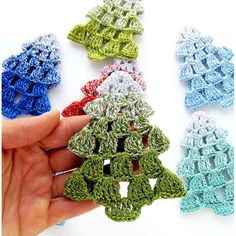 crocheted ornaments are being held in the palm of someone's left hand