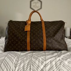 Lv Keepall 60 Travel Duffle/Duffel Bag With Luggage Tag, Lock With Key, And Dust Bag. Overall In Good Condition. No Exposed Piping. No Tears On The Canvas. Zipper Works Just Fine. Watermarks And Other Marks On The Vachetta As Pictured But Can Be Taken To A Cobbler To Even Out. Offers Are Welcome. Designer Brown Travel Bag For Trips, Brown Monogram Canvas Travel Bag With Leather Handles, Travel Bag With Luggage Sleeve In Monogram Canvas, Brown Monogram Canvas Travel Bag With Luggage Sleeve, Monogram Canvas Travel Bag With Luggage Sleeve, Designer Brown Tote Duffle Bag, Designer Brown Luggage For Travel, Designer Brown Travel Bag, Monogram Canvas Travel Bag