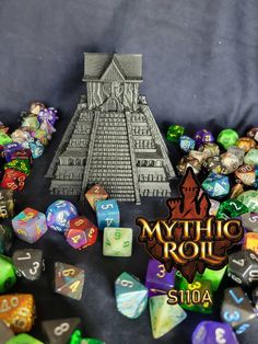 a pile of dice sitting on top of a table next to a pyramid shaped object