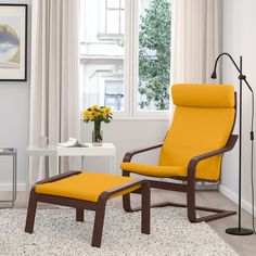 a yellow chair and footstool in a white living room with a painting on the wall