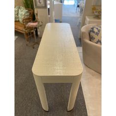 a white table sitting on top of a carpeted floor