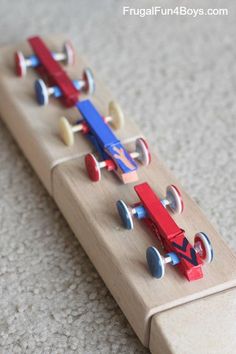 a wooden toy car is on the floor