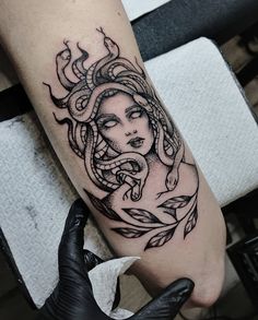 a woman's arm with a tattoo on it and an octopus in the middle