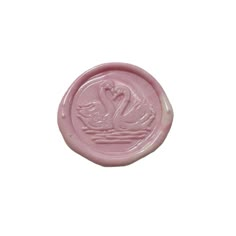 a pink wax stamp with a swan on it's face and the word love written in