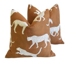 two brown and white pillows with leopards on them