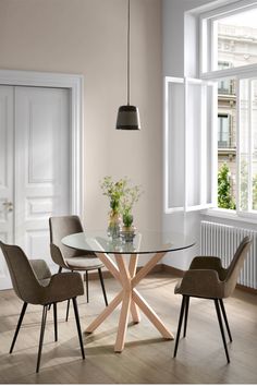 a glass table with four chairs around it