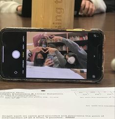 a cell phone sitting on top of a wooden table