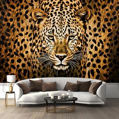 a living room with a couch and a leopard wall mural