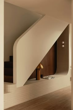 the interior of a house with wooden floors and white walls, including a stair case