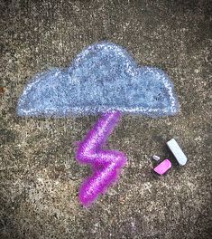 a chalk drawing of a cloud with lightning drawn on the ground next to it and two cell phones