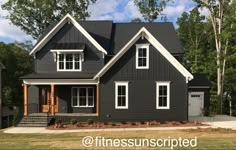 a gray house with white trim and windows