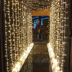 the entrance to a building is decorated with christmas lights and garlands on both sides