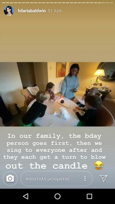 two women and three children sitting at a table in a hotel room, with the caption