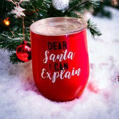 a red wine glass with the words dear santa i can explain on it in front of a christmas tree