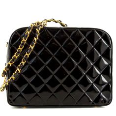 Rare Black Quilted Patent Leather Vanity Case In Size Large From The Chanel Spring 1995 Collection. Presented On The Runway Show By Supermodels Trish Goff And Nadege Du Bospertus. As Seen On Naomi Cambell For Vogue February 1995 And Nicole Richie. This Collectible Piece Crafted From Patent Leather Has A Diamond Stitching, Classic Interwoven Chain Top Handle, Gold Hardware And Four Bottom Feet. Good Vintage Condition With Some Light Wear Throughout Normal For Its Age: Slight Tarnishing And Small Chanel Spring 1995, Trish Goff, Vanity Bag, Chain Top, Chanel Spring, Nicole Richie, Vanity Case, Vintage Spring, Chanel Vintage