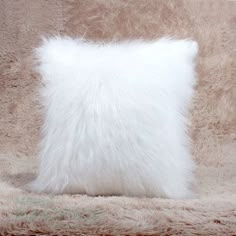 a fluffy white pillow sitting on top of a couch