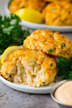 crab cakes on a plate with dipping sauce