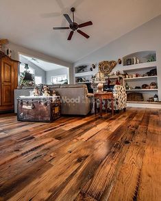 a living room filled with furniture and a ceiling fan in the middle of the room