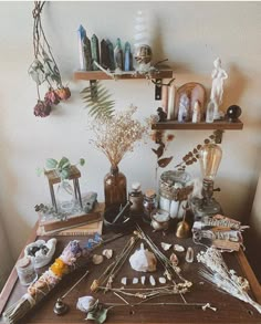 a wooden table topped with lots of different types of items on top of each other