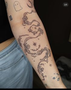 a woman's arm with tattoos on it, and an image of a dragon