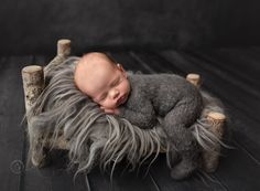 a baby sleeping on top of a stuffed animal