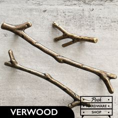 two brass branch handles are shown on the concrete floor with text overlay that reads, verwood hardware shop