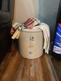 a laundry basket sitting on top of a wooden floor