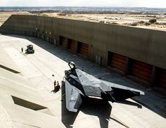 a fighter jet sitting on top of an airport tarmac