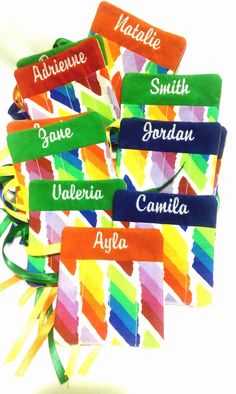 colorful name tags with names on them in different colors and sizes are tied to each other