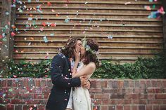 a man and woman kissing under confetti