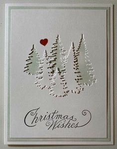 a christmas card with pine trees and a red heart on it's side, in white paper