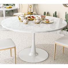 there is a white table with four tea cups on it and three chairs around it