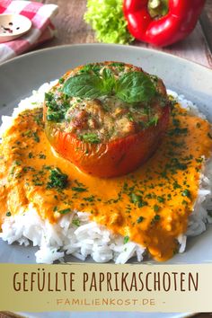 a white plate topped with rice covered in sauce