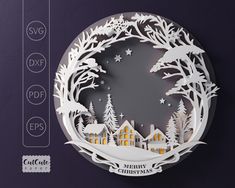 a paper cut christmas ornament with trees and houses in the snow, on a purple background