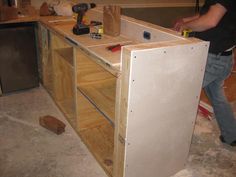 a man working on cabinets in a kitchen