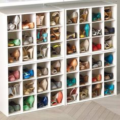 a white shoe storage unit filled with lots of shoes