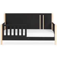 a black crib bed with white sheets and wooden slats on the bottom rail