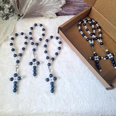 two necklaces and a box on a table