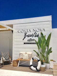 the sign for costanovaa beach club is displayed on the side of a building